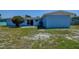 View of the home's backyard and patio, with sliding glass doors leading inside from the patio at 3841 Wahoo Se Dr, St Petersburg, FL 33705