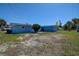 Backyard view of the blue house showing grass at 3841 Wahoo Se Dr, St Petersburg, FL 33705