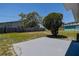 The backyard has a small concrete patio and is bordered by a wood fence and mature trees at 3841 Wahoo Se Dr, St Petersburg, FL 33705