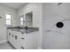 Modern bathroom with a double granite vanity top and walk-in shower with marble tiling at 3841 Wahoo Se Dr, St Petersburg, FL 33705