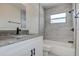 Updated bathroom features tiled walls, sleek black fixtures, and granite vanity at 3841 Wahoo Se Dr, St Petersburg, FL 33705