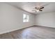 Bright bedroom with wood-look flooring, a ceiling fan, and a large window with natural light at 3841 Wahoo Se Dr, St Petersburg, FL 33705