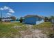 Exterior view of the blue house on a sunny day at 3841 Wahoo Se Dr, St Petersburg, FL 33705