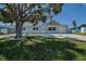 Charming single-story home featuring a large tree and a well-manicured front lawn at 3841 Wahoo Se Dr, St Petersburg, FL 33705