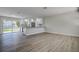 Open kitchen and living area with sleek floors and sliding glass doors to the backyard at 3841 Wahoo Se Dr, St Petersburg, FL 33705