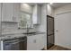 Modern kitchen with stainless steel appliances, granite countertops, and white cabinetry at 3841 Wahoo Se Dr, St Petersburg, FL 33705