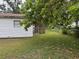 Backyard featuring a well-maintained lawn and mature trees, offering ample space at 3918 E Clifton St, Tampa, FL 33610