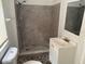 A bathroom featuring a tiled shower, a white vanity, and a toilet at 3918 E Clifton St, Tampa, FL 33610