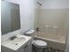Clean bathroom features a vanity with a mirror and tub with shower at 3918 E Clifton St, Tampa, FL 33610