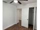 Bedroom featuring a ceiling fan, hardwood floors, and a closet for optimal storage at 3918 E Clifton St, Tampa, FL 33610