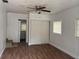 A bedroom with neutral walls, wood-look floors, and a closet with sliding doors at 3918 E Clifton St, Tampa, FL 33610