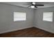 Comfortable bedroom with wood-look flooring and two windows at 3918 E Clifton St, Tampa, FL 33610