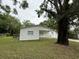 Charming home featuring a front porch and mature trees, set on a well-maintained lawn at 3918 E Clifton St, Tampa, FL 33610