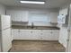 Bright kitchen features white cabinets, granite countertops, and stainless steel appliances at 3918 E Clifton St, Tampa, FL 33610