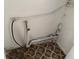 A utility room with exposed pipes and connections, plus patterned tile flooring at 3918 E Clifton St, Tampa, FL 33610