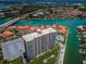 Attractive aerial view of condo building with pool and surrounding waterfront properties, docks and beautiful landscaping at 4900 Brittany S Dr # 502, St Petersburg, FL 33715