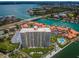 Stunning aerial view of condo building near waterfront with pool and boat docks, surrounded by lush landscaping at 4900 Brittany S Dr # 502, St Petersburg, FL 33715