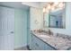 Bathroom with granite countertops and shower with glass door at 4900 Brittany S Dr # 502, St Petersburg, FL 33715