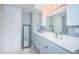 Bathroom featuring white cabinets, a large mirror, and ample lighting perfect for everyday routines at 4900 Brittany S Dr # 502, St Petersburg, FL 33715