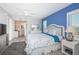 Bright bedroom boasts a queen bed, a desk, a bathroom, and a balcony view at 4900 Brittany S Dr # 502, St Petersburg, FL 33715