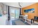 Bedroom with a balcony, office desk and modern ocean-themed artwork at 4900 Brittany S Dr # 502, St Petersburg, FL 33715