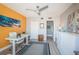 Bright bedroom featuring a modern ceiling fan, an accent wall, and a desk at 4900 Brittany S Dr # 502, St Petersburg, FL 33715