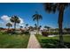 Beautiful community pool area with lush landscaping, brick-paved walkway, and clear blue skies at 4900 Brittany S Dr # 502, St Petersburg, FL 33715