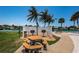 Community grilling area with picnic table, grill, white fencing, and waterfront views at 4900 Brittany S Dr # 502, St Petersburg, FL 33715