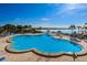 Expansive community pool featuring separate wading areas for lounging under sunny skies near the waterfront at 4900 Brittany S Dr # 502, St Petersburg, FL 33715