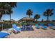 Relaxing poolside lounge area with chairs, tables, tiki umbrellas, and waterfront views at 4900 Brittany S Dr # 502, St Petersburg, FL 33715