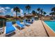 Inviting poolside seating with lounge chairs, tables, umbrellas, and lush landscaping at 4900 Brittany S Dr # 502, St Petersburg, FL 33715