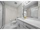 Well-lit bathroom featuring a combination shower and bathtub, a modern toilet, and marble countertops at 5018 S The Riviera St, Tampa, FL 33609
