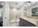 Modern bathroom features a glass-enclosed shower, granite vanity, and updated fixtures at 5018 S The Riviera St, Tampa, FL 33609