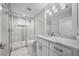 Bright bathroom showcases modern fixtures, a glass shower, and a well-lit vanity with marble countertops at 5018 S The Riviera St, Tampa, FL 33609