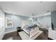 Bright bedroom featuring hardwood floors, a ceiling fan, and decorative bed frame at 5018 S The Riviera St, Tampa, FL 33609
