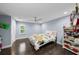 Charming bedroom with a ceiling fan, hardwood floors, and bright natural light from the window at 5018 S The Riviera St, Tampa, FL 33609