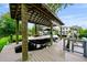A covered boat dock featuring a boat lift and modern boat near the waterfront home at 5018 S The Riviera St, Tampa, FL 33609