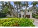 Elegant two-story home featuring lush landscaping, a two-car garage, and a well-maintained front yard at 5018 S The Riviera St, Tampa, FL 33609