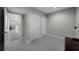 Hallway with neutral walls, light flooring, doors, and decorative rug leading to exterior at 5018 S The Riviera St, Tampa, FL 33609
