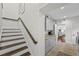 Hallway with stairs and built-in cabinets, leading to a glimpse of the bright, airy kitchen at 5018 S The Riviera St, Tampa, FL 33609