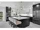 Modern kitchen with a large center island, stainless steel appliances, and sleek black and white cabinetry at 5018 S The Riviera St, Tampa, FL 33609