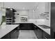 Well-equipped kitchen featuring black and white cabinetry, a kitchen island, and stainless steel appliances at 5018 S The Riviera St, Tampa, FL 33609