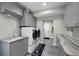 Well-organized laundry room with modern gray cabinets, washer, dryer, and sink at 5018 S The Riviera St, Tampa, FL 33609