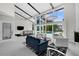 Bright living room with high ceilings, large windows overlooking the pool, and a stylish seating area at 5018 S The Riviera St, Tampa, FL 33609
