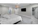 Bright primary bedroom featuring a walk-in closet and mounted television at 5018 S The Riviera St, Tampa, FL 33609