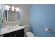 Modern powder room with decorative mirror, floating vanity, and designer accents at 5018 S The Riviera St, Tampa, FL 33609