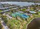 Aerial view of the community showing tennis courts, pools, townhomes, lakes and landscaping at 5094 Starfish Se Dr # E, St Petersburg, FL 33705