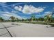 Outdoor community basketball court with hoops and palm trees at 5094 Starfish Se Dr # E, St Petersburg, FL 33705