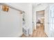 Well-organized closet with built-in shelving, wooden hangers, and tile flooring at 5094 Starfish Se Dr # E, St Petersburg, FL 33705