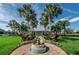 A beautiful clubhouse with a fountain and palm-lined walkway, set against a bright blue sky at 5094 Starfish Se Dr # E, St Petersburg, FL 33705